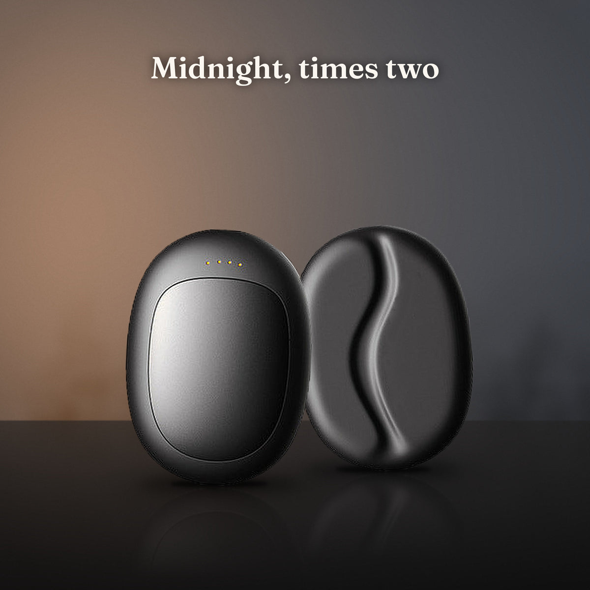 A pair of WarmNest Twin warmers in Midnight by a snowy window at night